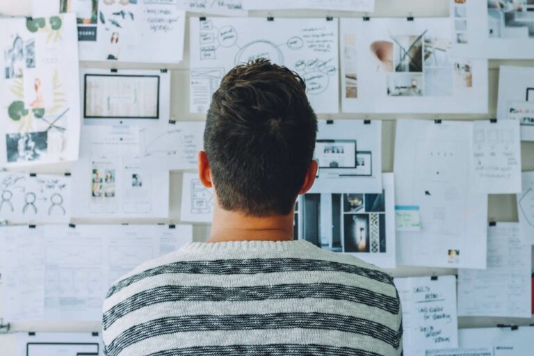 man thinking looking at wall map