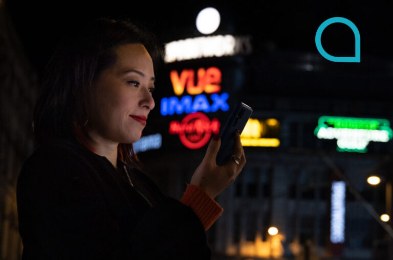 Woman searching phone at night