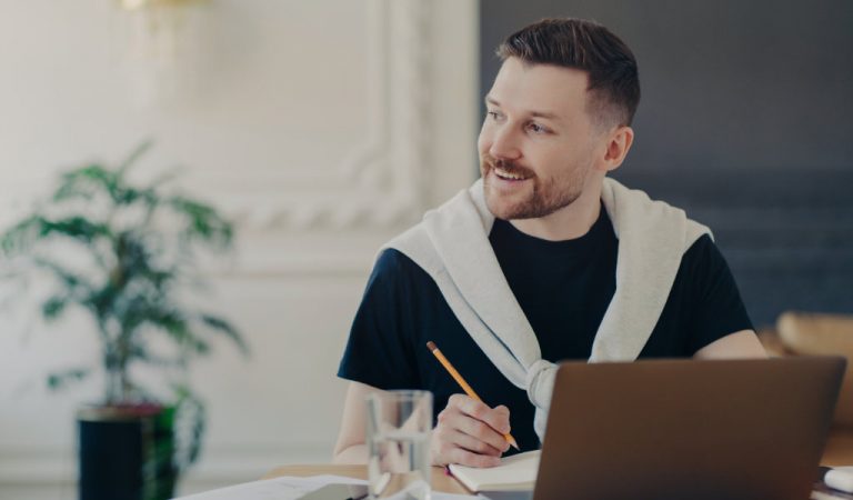 Man sat at laptop research a content plan